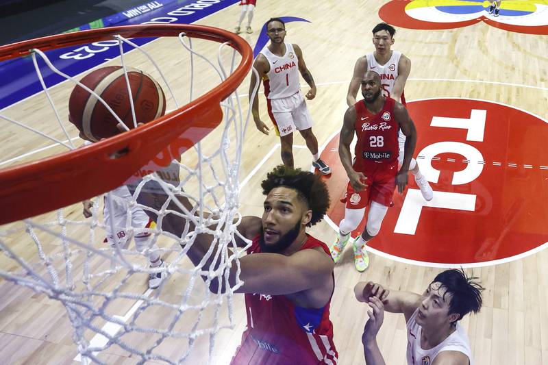 George Conditt (1) of Puerto Rico drives to the basket against Hu Mingxuan (3) of China in the second half during the FIBA Basketball World Cup Group B game at Araneta Coliseum on Monday August 30, 2023 in Manila, Philippines. (Yong Teck Lim/Pool Photo via AP)