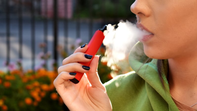 beautiful brunette smoke electronic cigarette